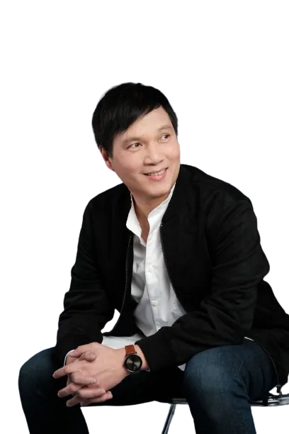 Atty. Tony Roman III, seated and smiling, in a dark jacket and white shirt